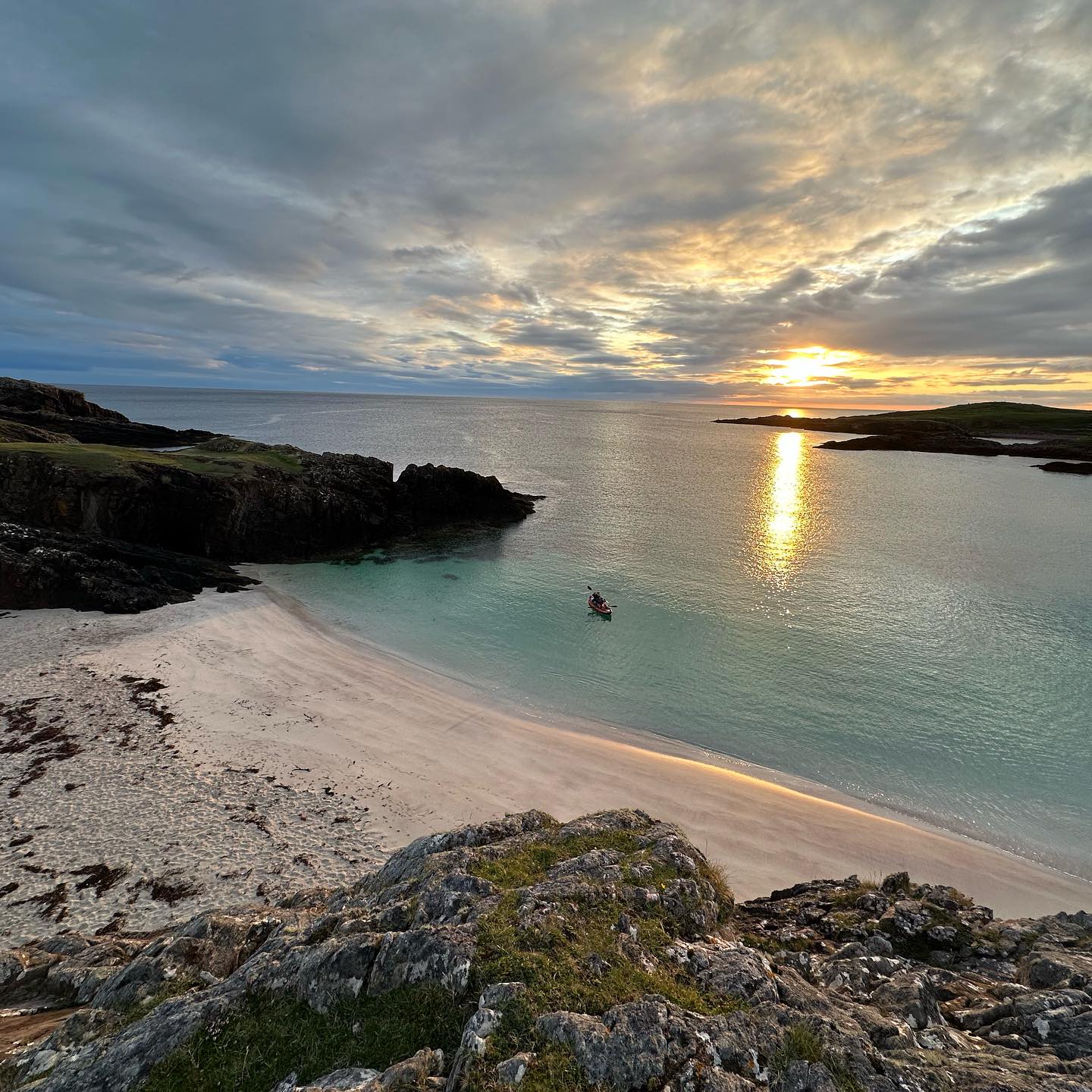 Sunset reflected across a sandy bay at Clachtoll.