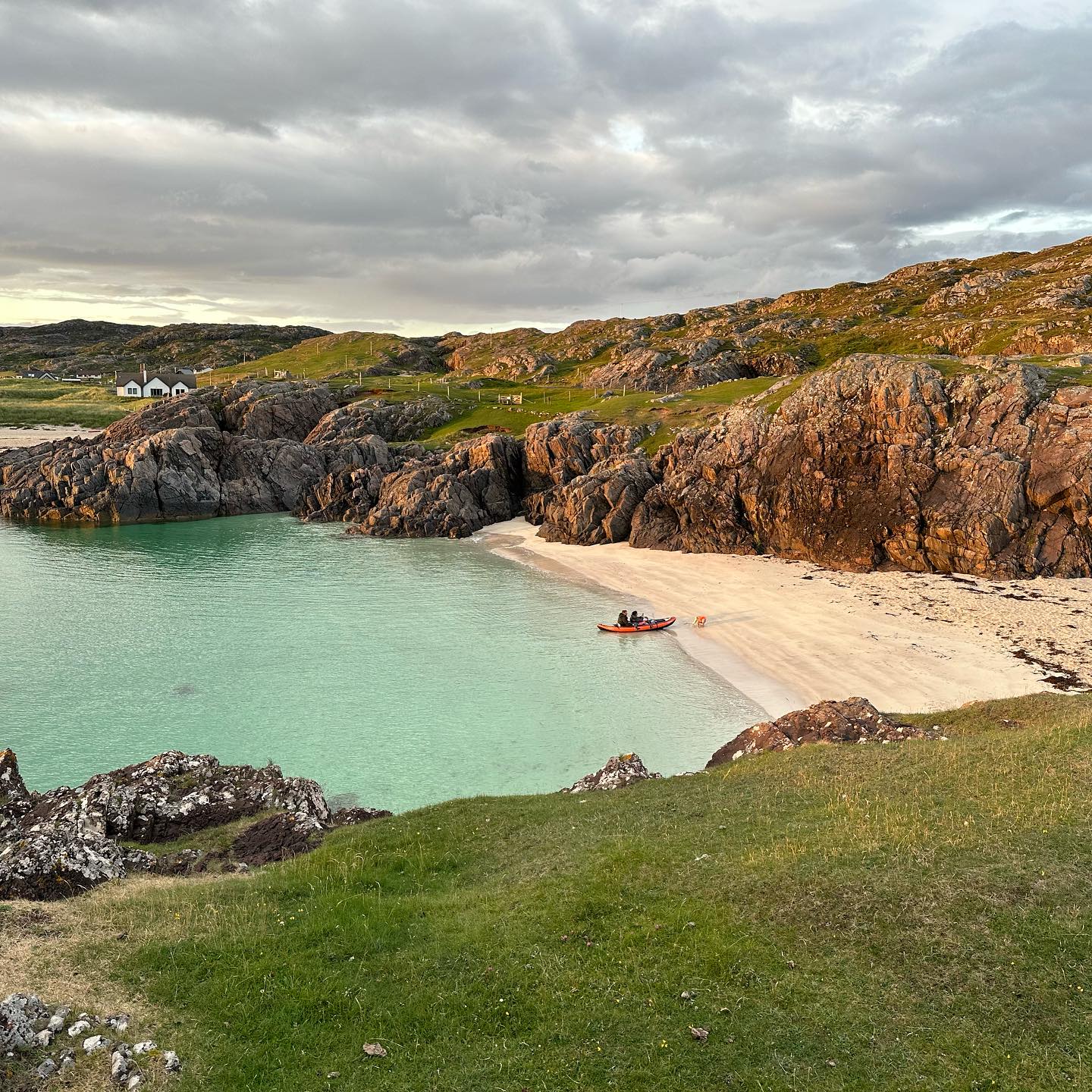 Turquoise water and pale sand between rocky headlands at Clachtoll.