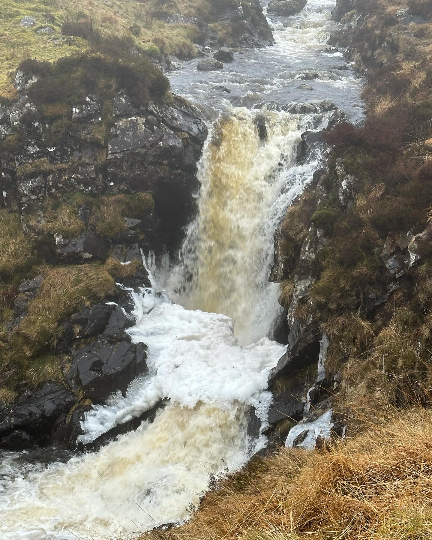 White water cascading through a narrow rocky channel.