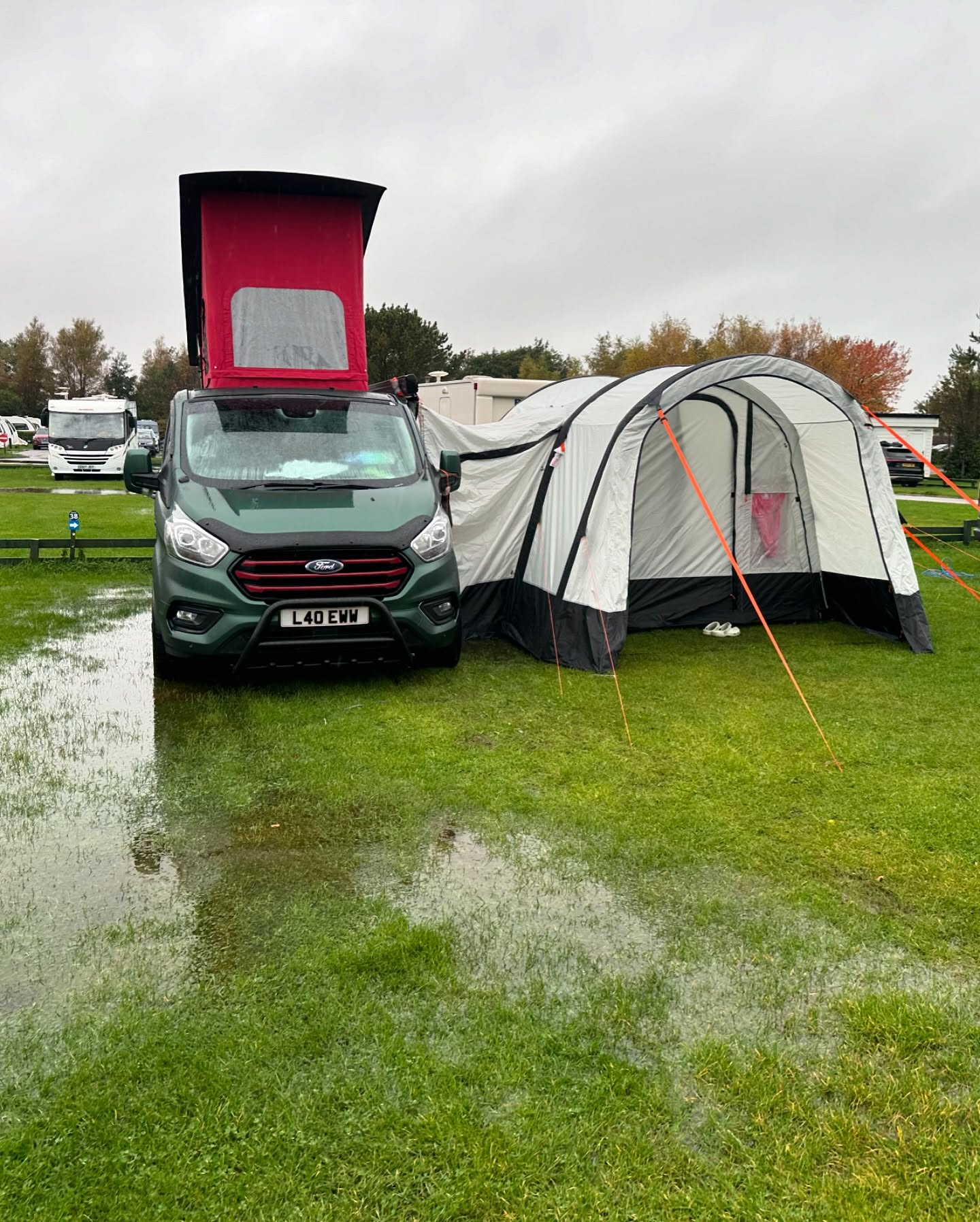 The camper and its awning at the Lakeland campsite after heavy rain.